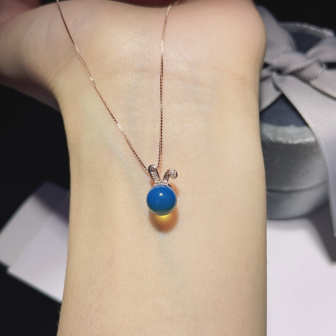 Autumn's Whisper Jewelry: 18k Gold Embedded Dominican Blue Amber Pendant with Adorable Rabbit